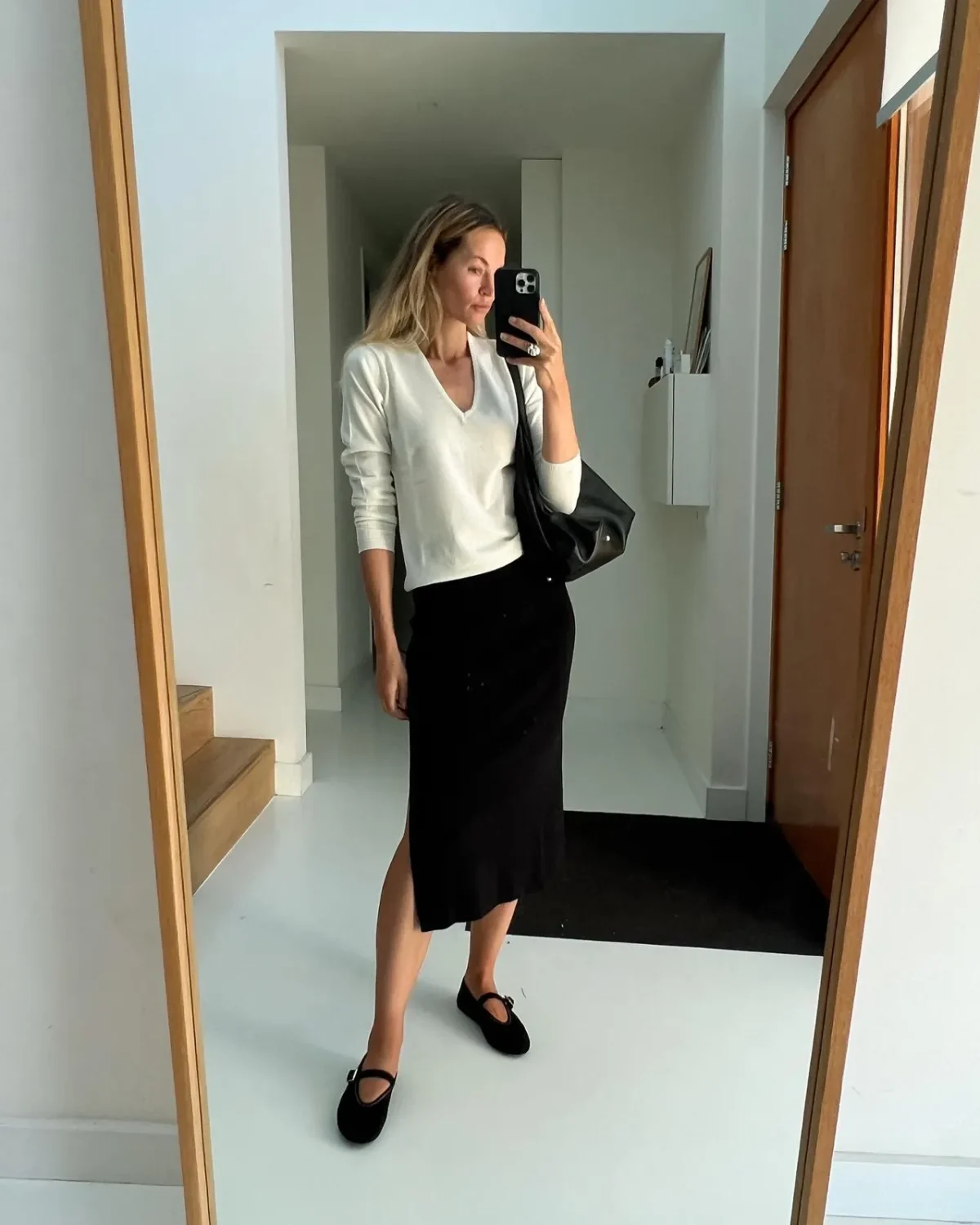 Minimalist business formal outfit with ballet flats and a black pencil skirt