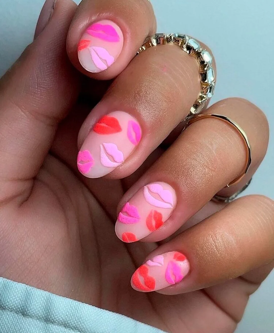 Cute red and pink Valentine's Day nails with kisses.