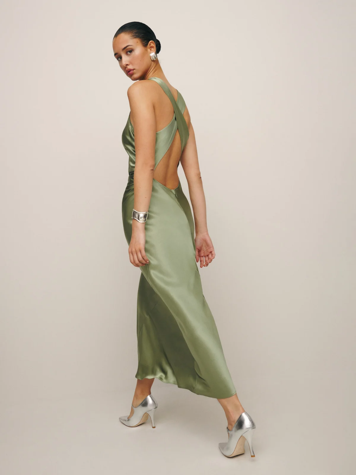 Olive green silk dress with backless details.