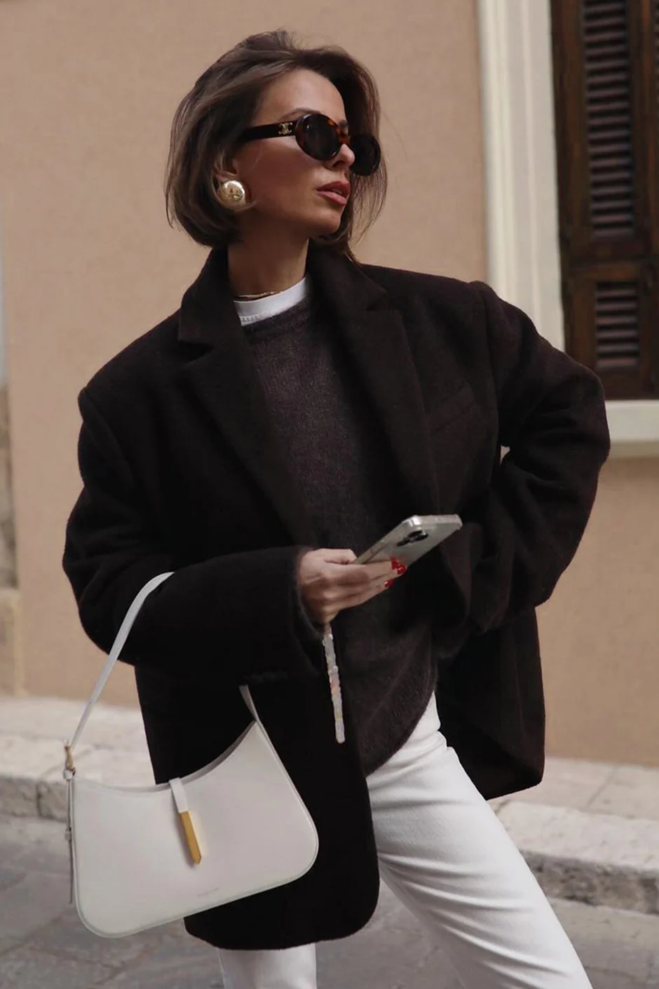 White DeMellier bag styled with a black blazer.